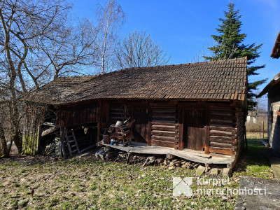 Drewniana chata z działką i zabudowaniami
